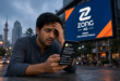 Pakistani mobile user checking rising Zong bundle prices on smartphone after price hike